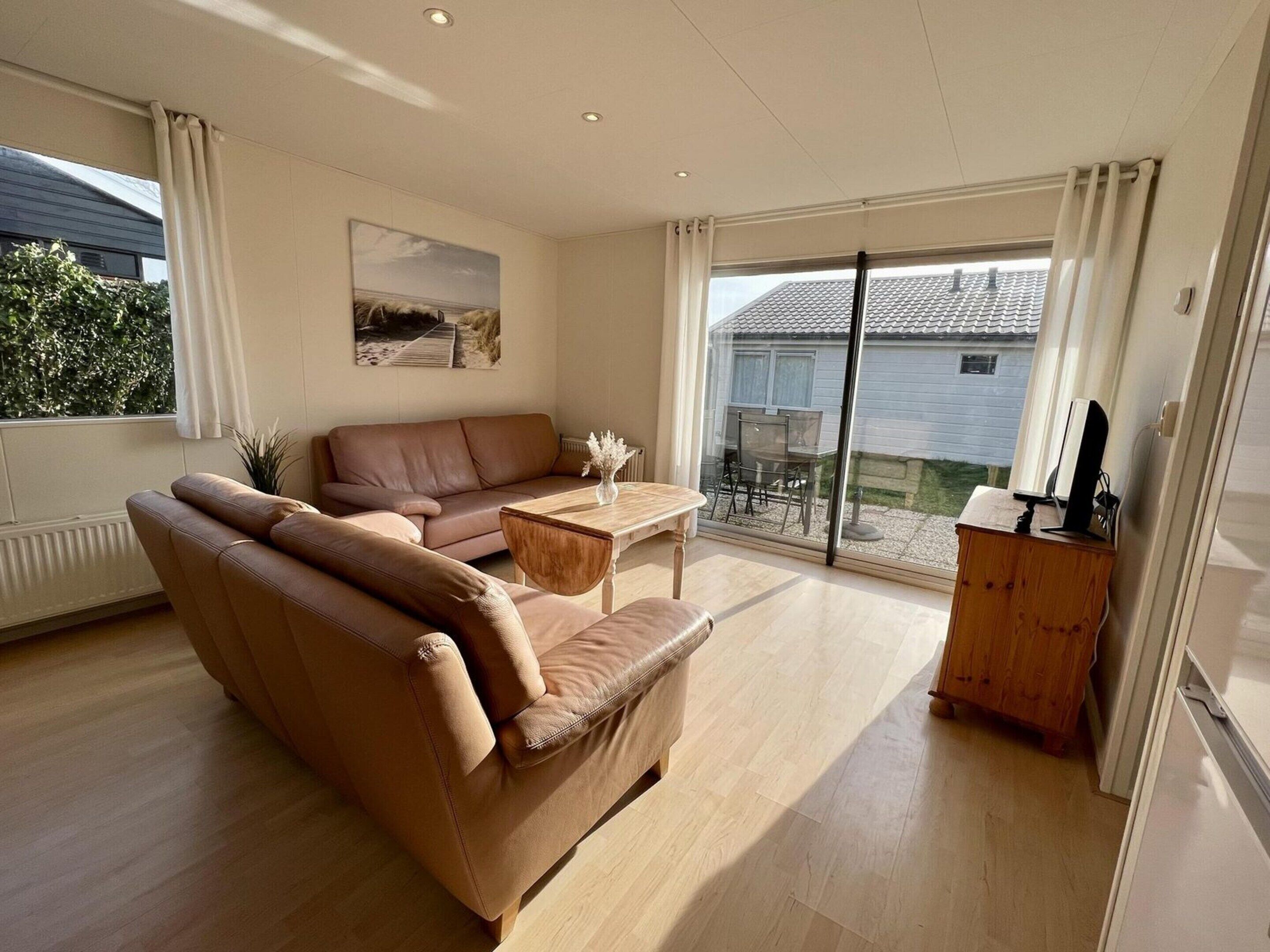 Hus – deluxe, 2 soverom | Oppholdsrom | Peis