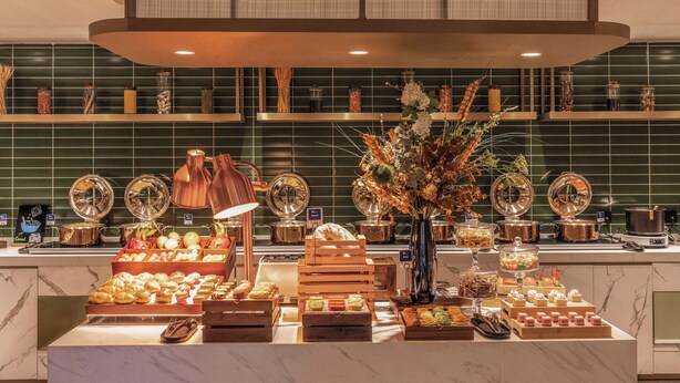 A buffet setup with various food items and a decorative centerpiece. - xadytdtbycmljd (Xi'an)