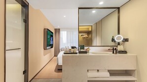 A modern bathroom with a large mirror, a TV mounted on the wall, and a vanity with a sink and towel rack. - xadytdtbycmljd (Xi'an)