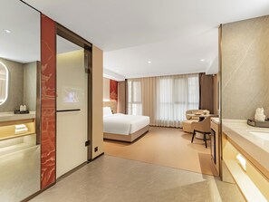 A modern hotel room with a bed, a desk, a chair, a bathroom with a mirror, and a TV screen. - xadytdtbycmljd (Xi'an)