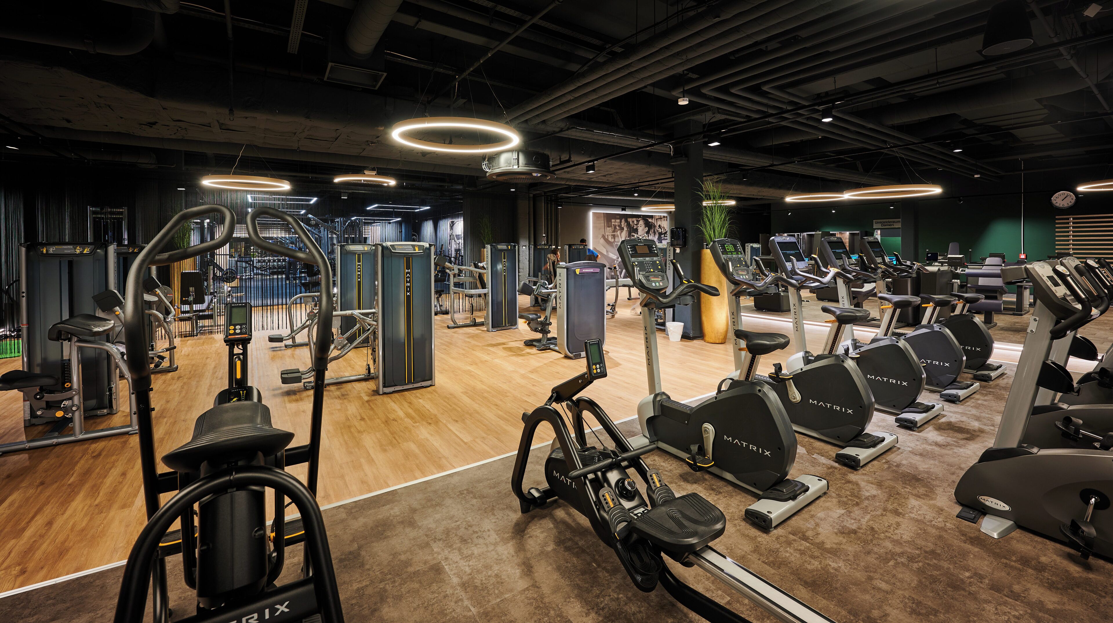 A gym with various exercise equipment, including treadmills and weight machines.