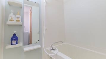 Combined shower/tub, hair dryer, slippers, towels