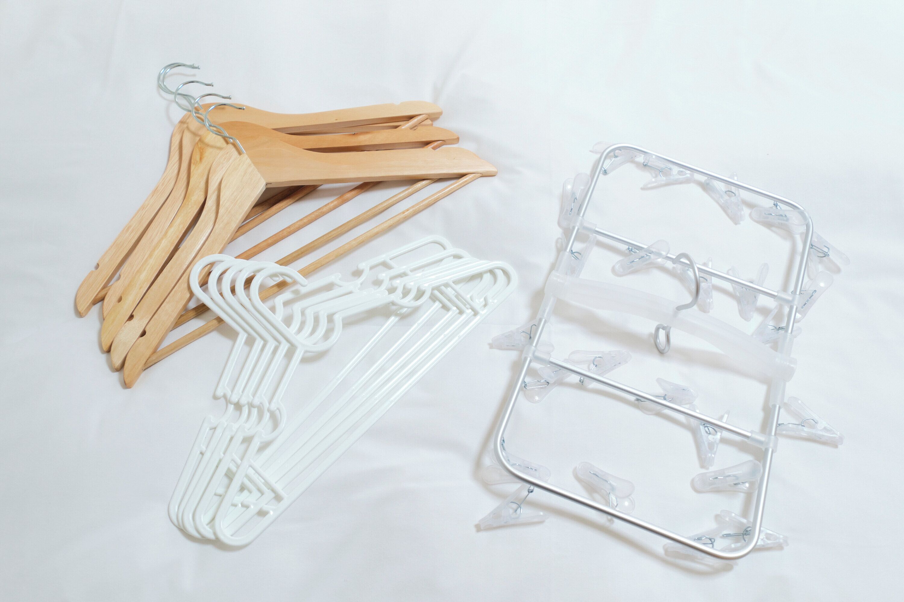 A set of wooden hangers and a plastic hanger organizer.