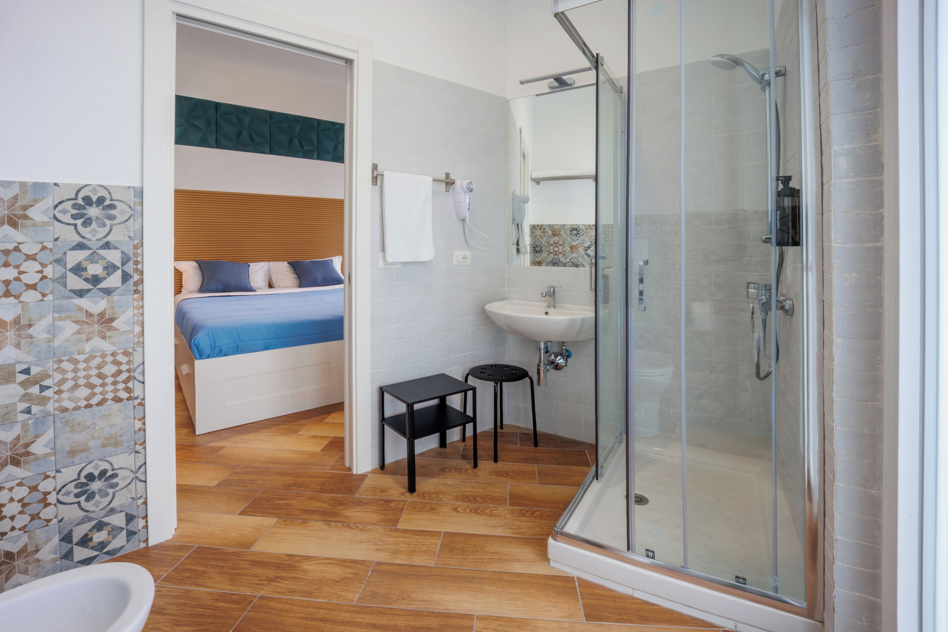 A bathroom with a shower, sink, and toilet.