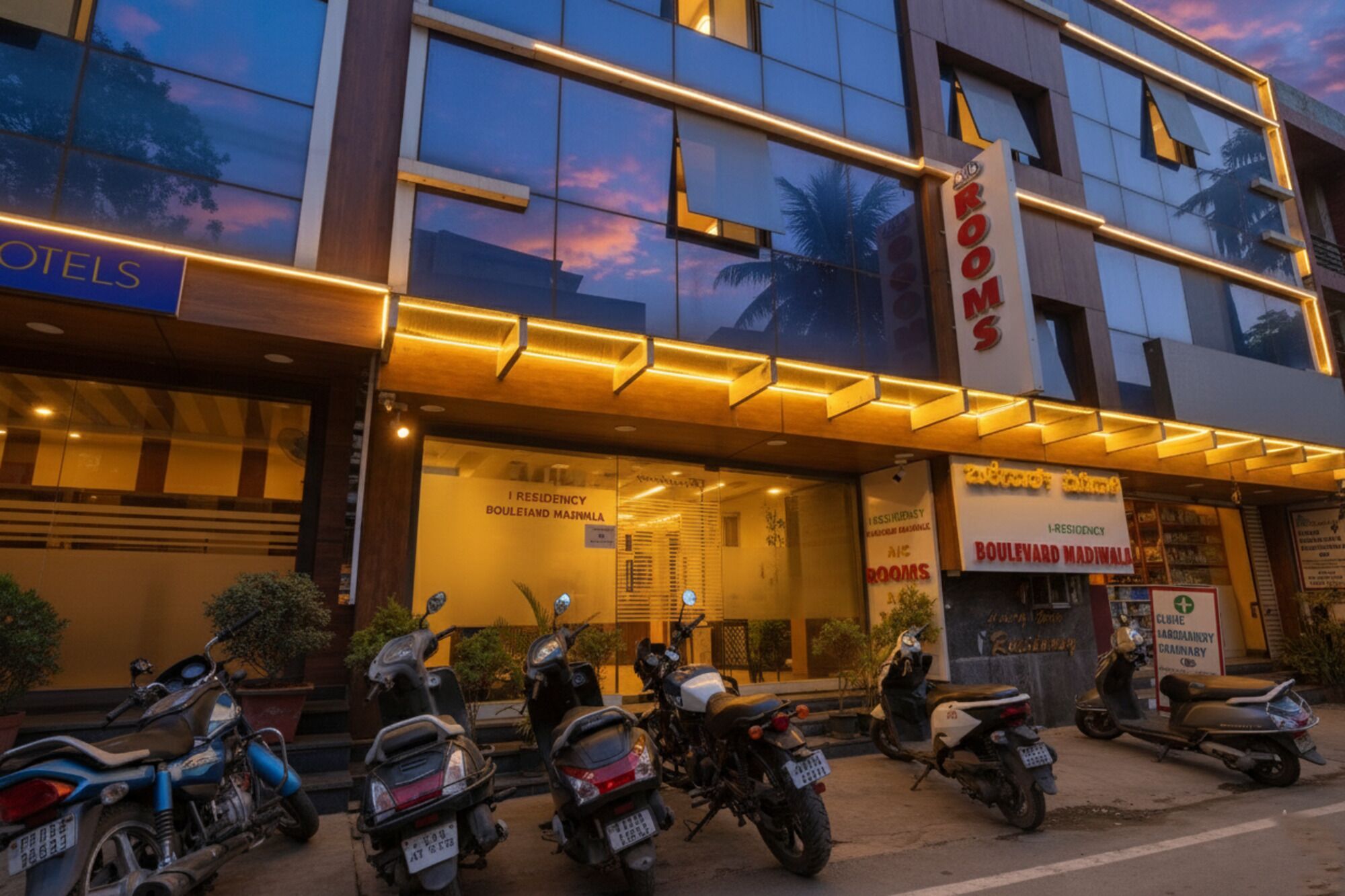 A hotel with a sign indicating 'I Residency Boulevard Madinalli' and 'Rooms'.