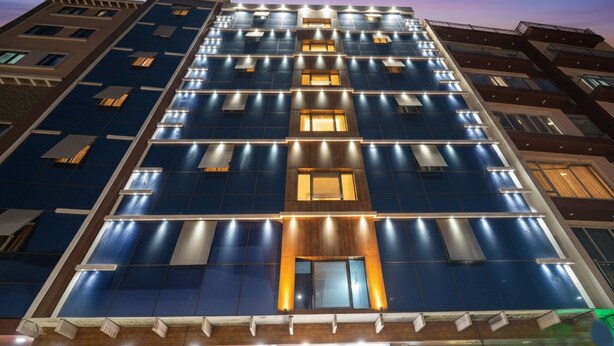 A multi-story hotel with a modern facade, featuring a grid of windows and illuminated panels. - FabHotel I Residency - Koramangala (Nr St. John's Hospital) (Bengaluru)