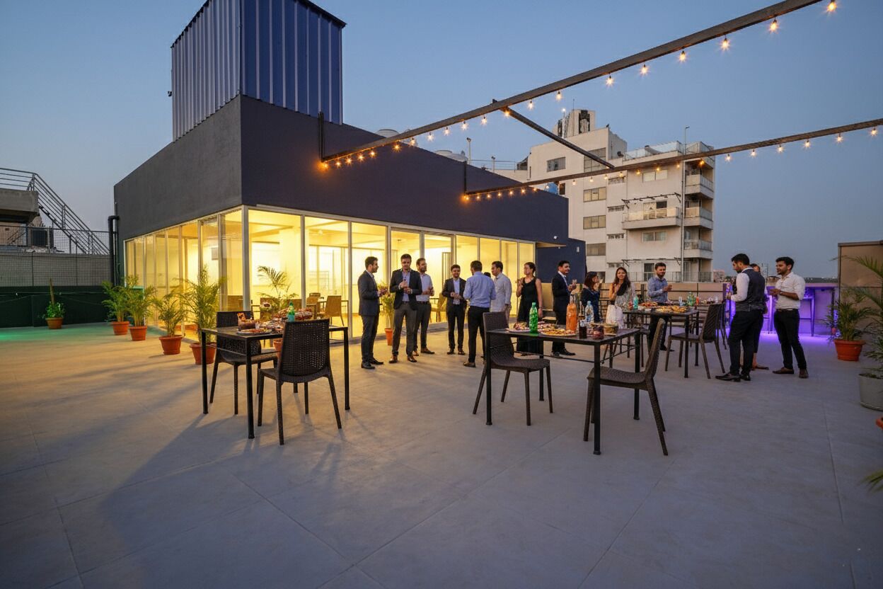 A rooftop gathering with outdoor seating and string lights.