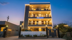 A modern multi-story hotel with a prominent 'Tab Hotels' sign. - FabHotel RR Premium (Gurugram)