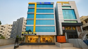 A modern hotel building with a prominent 'fab hotels' sign, 'hotel dlf inn' signage, and 'luxury rooms' text. - Fabhotel Dlf Inn (Hyderabad)