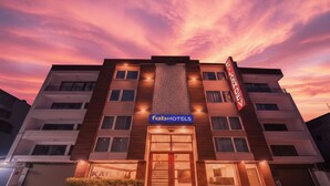 A multi-story hotel with a prominent sign for 'fabHOTELS' and a 'KAI ASHO' store on the ground floor. - Fabhotel The Kailash Dev (New Delhi)