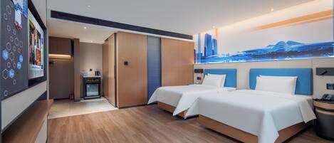 A modern hotel room with two beds, a cityscape mural, a kitchenette, and a wooden floor.