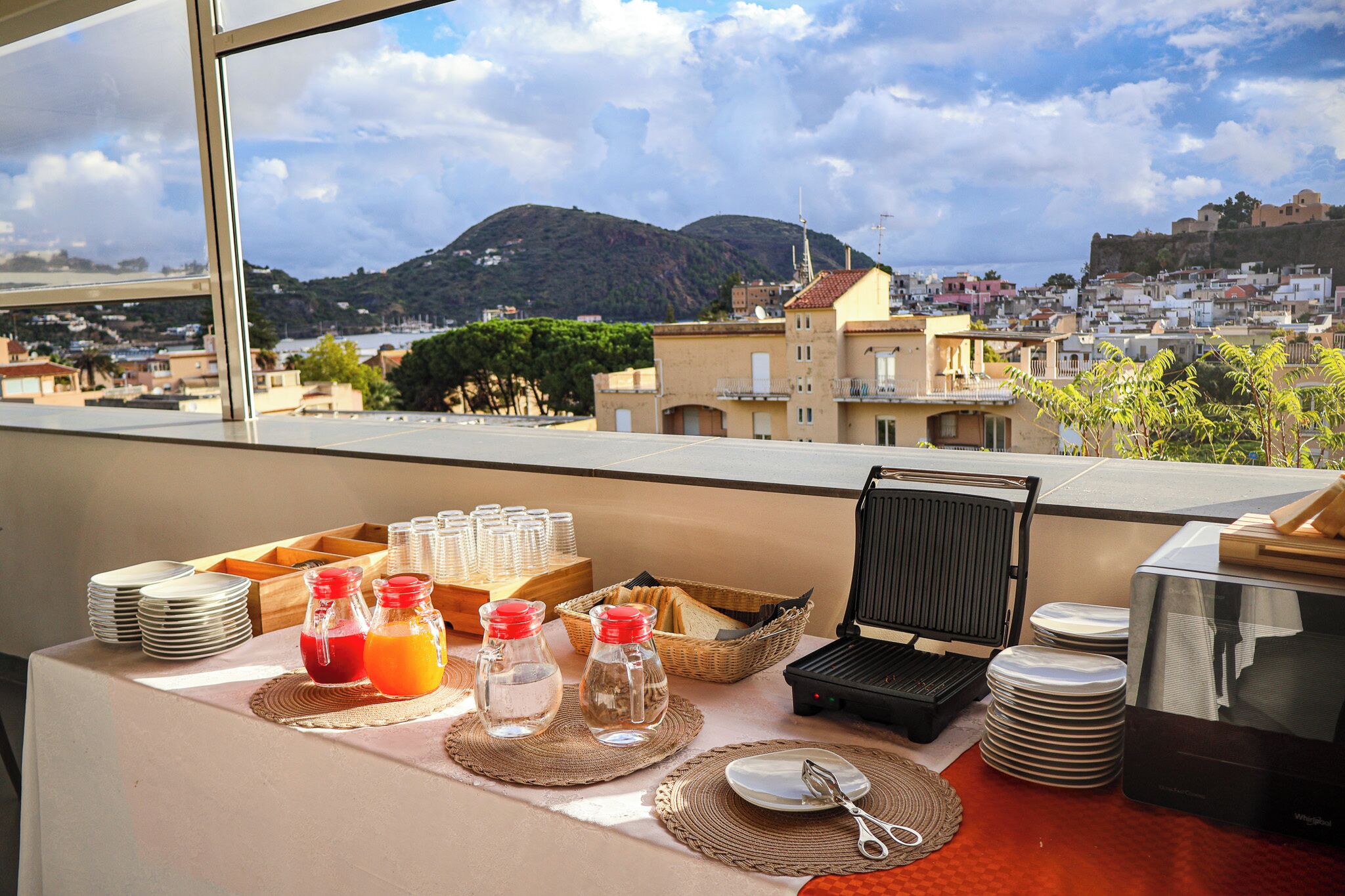 A breakfast setup with a view of a mountainous town.