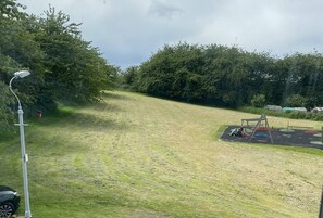 Enjoy a peaceful family retreat with a playground and lush green surroundings.