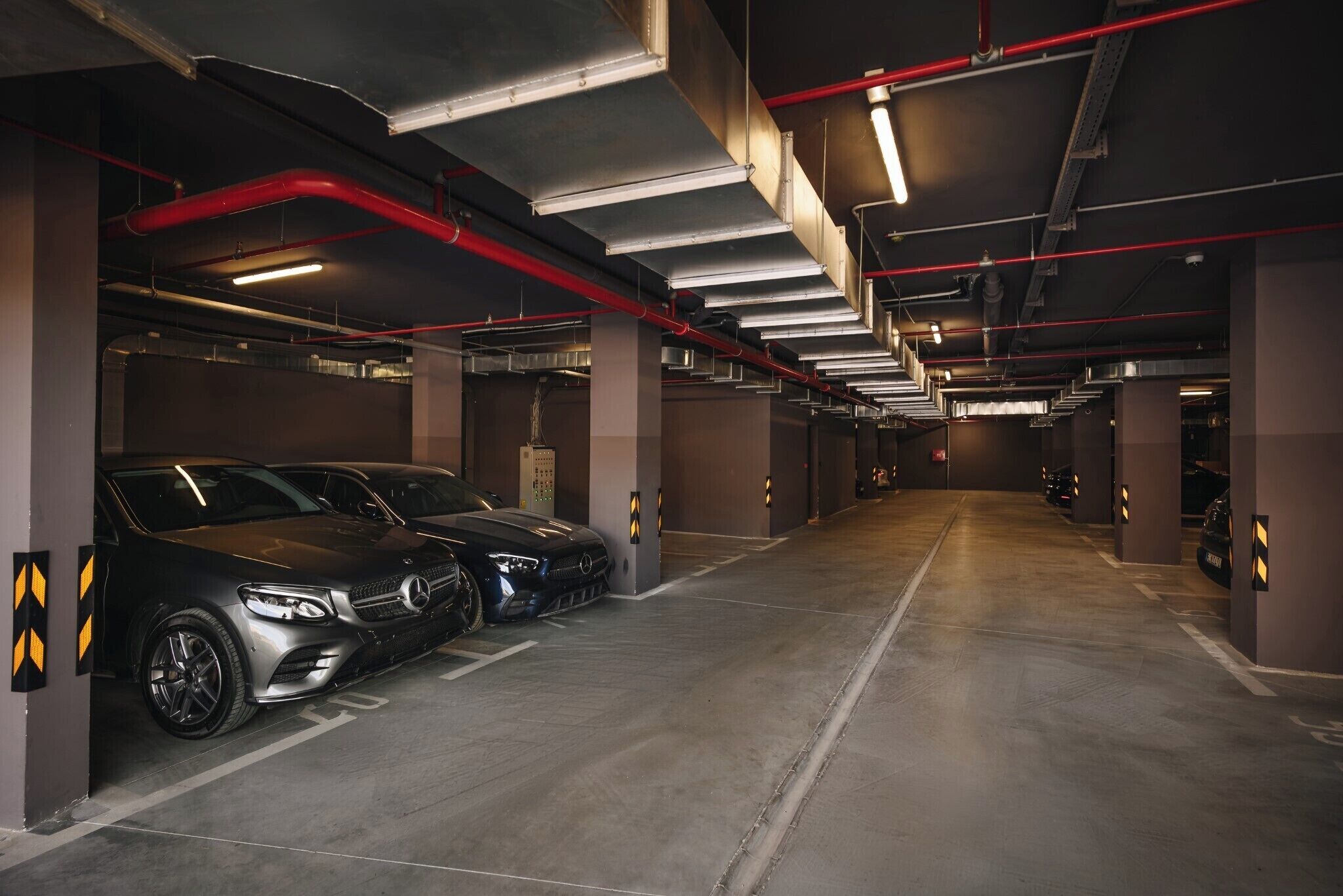 Eine mehrgeschossige Tiefgarage mit in dafür vorgesehenen Stellplätzen geparkten Autos.