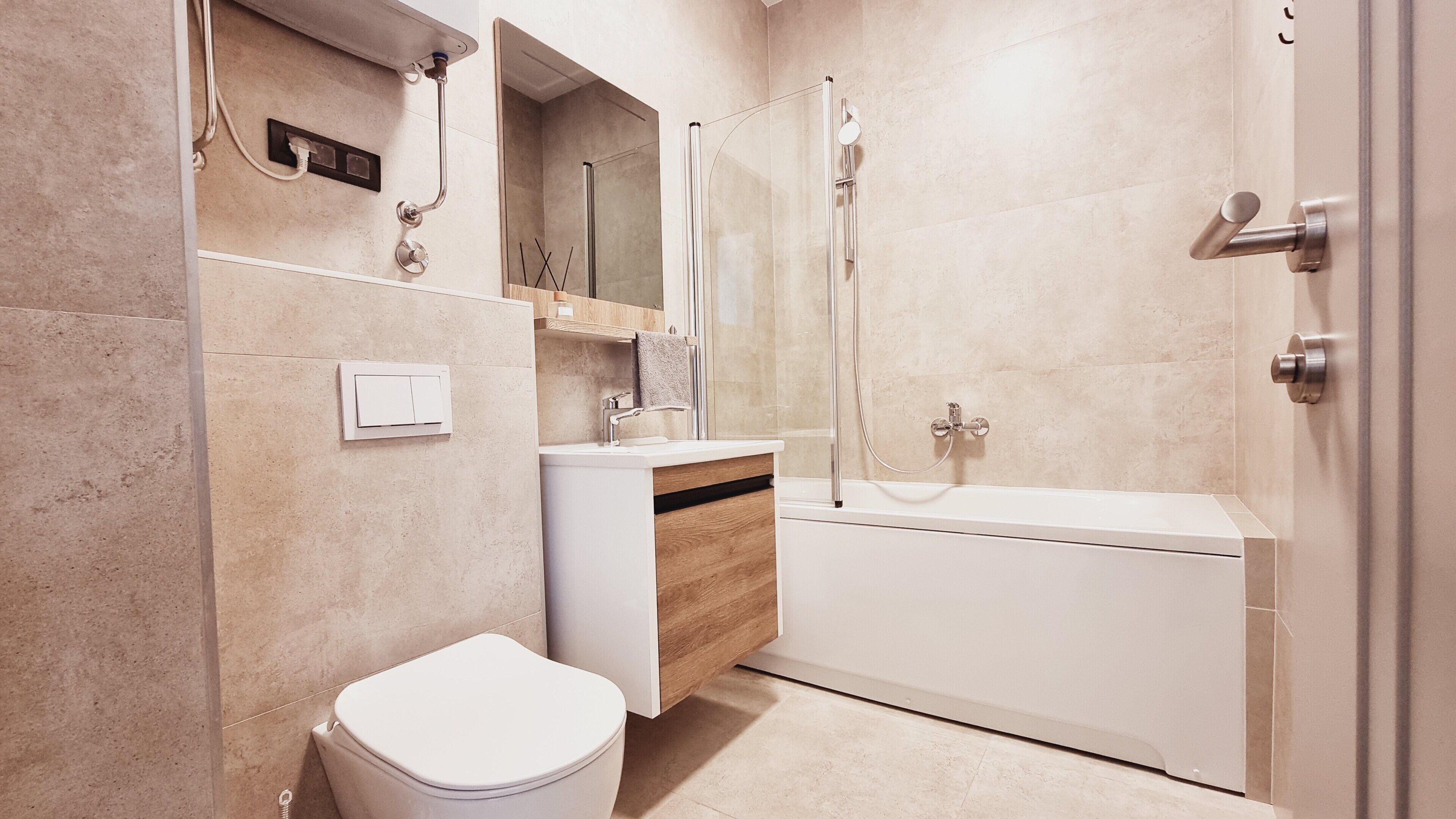 A modern bathroom with a toilet, sink, and bathtub.