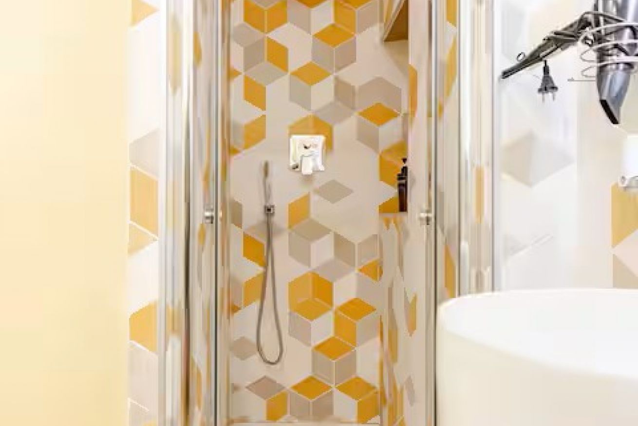 A bathroom with a shower, a toilet, and a sink.