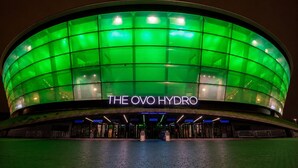 A large, circular building with a green glass facade and the name 'THE OVO HYDRO' illuminated on the front. - Modern Apex Flat / King Bed/3 Guests/ Parking/WiFi (Argyll and Bute Council)