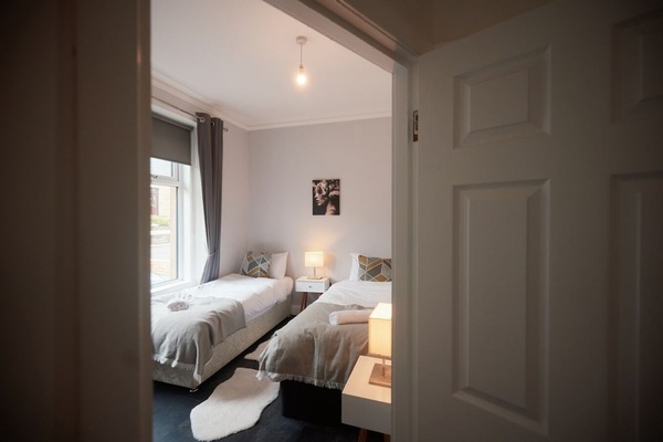 Rest easy in this tidy bedroom with soft bedding and fresh towels.
Thick curtains offer both privacy and a cozy feel.