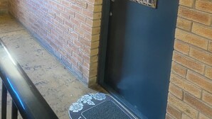 A dark door with the number 44, a metal handle, and a keyhole.