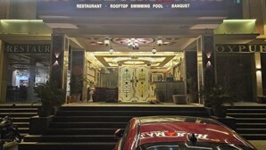 The entrance of Hotel Amarah with a sign indicating it has a restaurant, rooftop swimming pool, and banquet facilities. - Hotel Amarah (Jaipur)