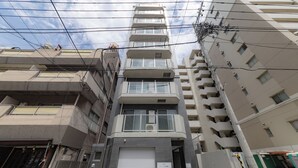 A multi-story hotel building with a modern architectural design, featuring balconies and a central entrance. - Cure Azumabashi by Tranova (Tokyo)