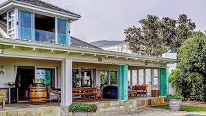 A house with a covered patio, outdoor seating, a barbecue area, and a swimming pool. - 4-bedroom house overlooking the sea on the cliff path in Hermanus (Hermanus)