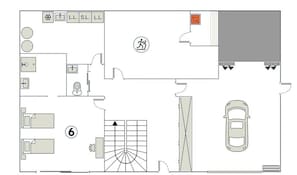A floor plan with a kitchen, a bathroom, a living area, and a parking space.