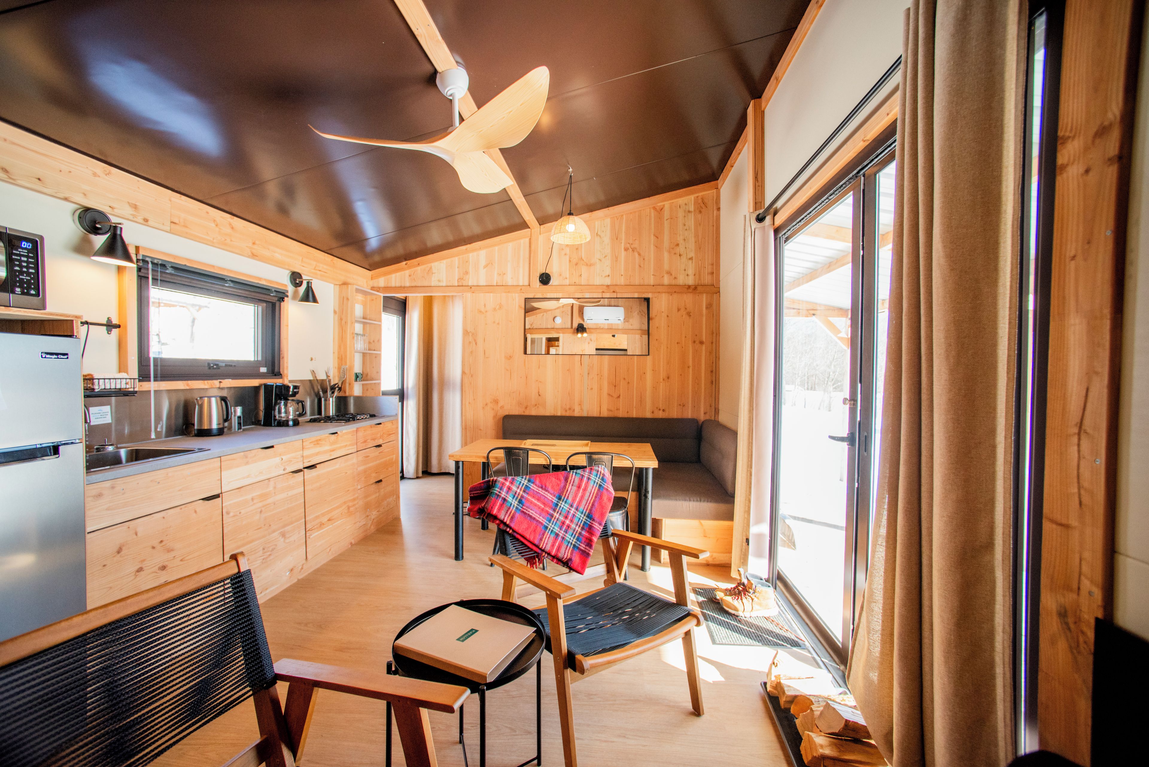 A modern kitchen with wooden cabinets, a built-in stove, and a microwave.