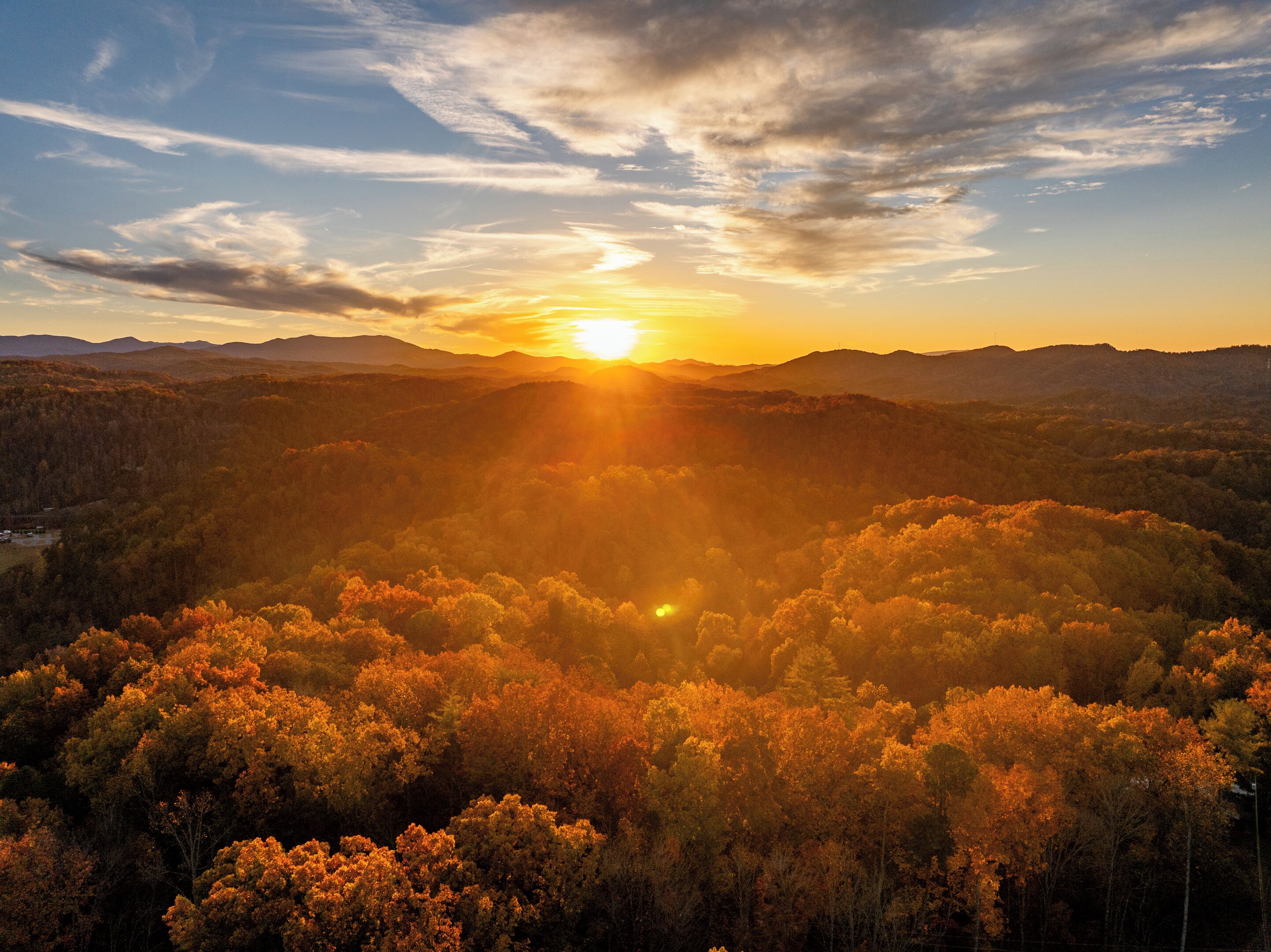 A mountainous landscape with a sunset.