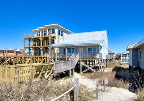 Enjoy stunning ocean views from the elevated balcony and covered deck area of this beachfront property.