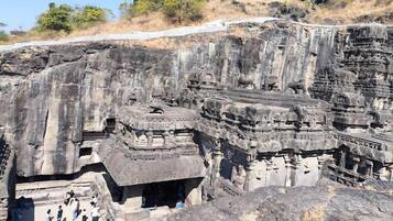 A large rock-cut temple complex with intricate carvings and multiple levels.