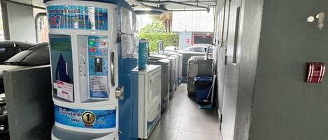 A water dispenser and a washing machine in a parking garage.