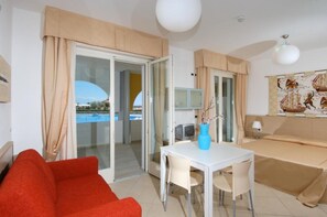 Relax in this stylish room with a sliding door leading to an outdoor area, a flat-screen TV, and a comfortable bed.
