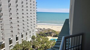 A high-rise hotel with a view of the beach and a pool. - Royale Palms 801H Oceanview Studio in Kingston (Myrtle Beach)