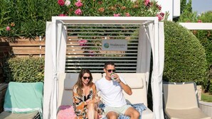A pool area with a covered seating area, lounge chairs, and a pool with two children swimming. - Persi by the beach! Thalasses villas (Rethymno)
