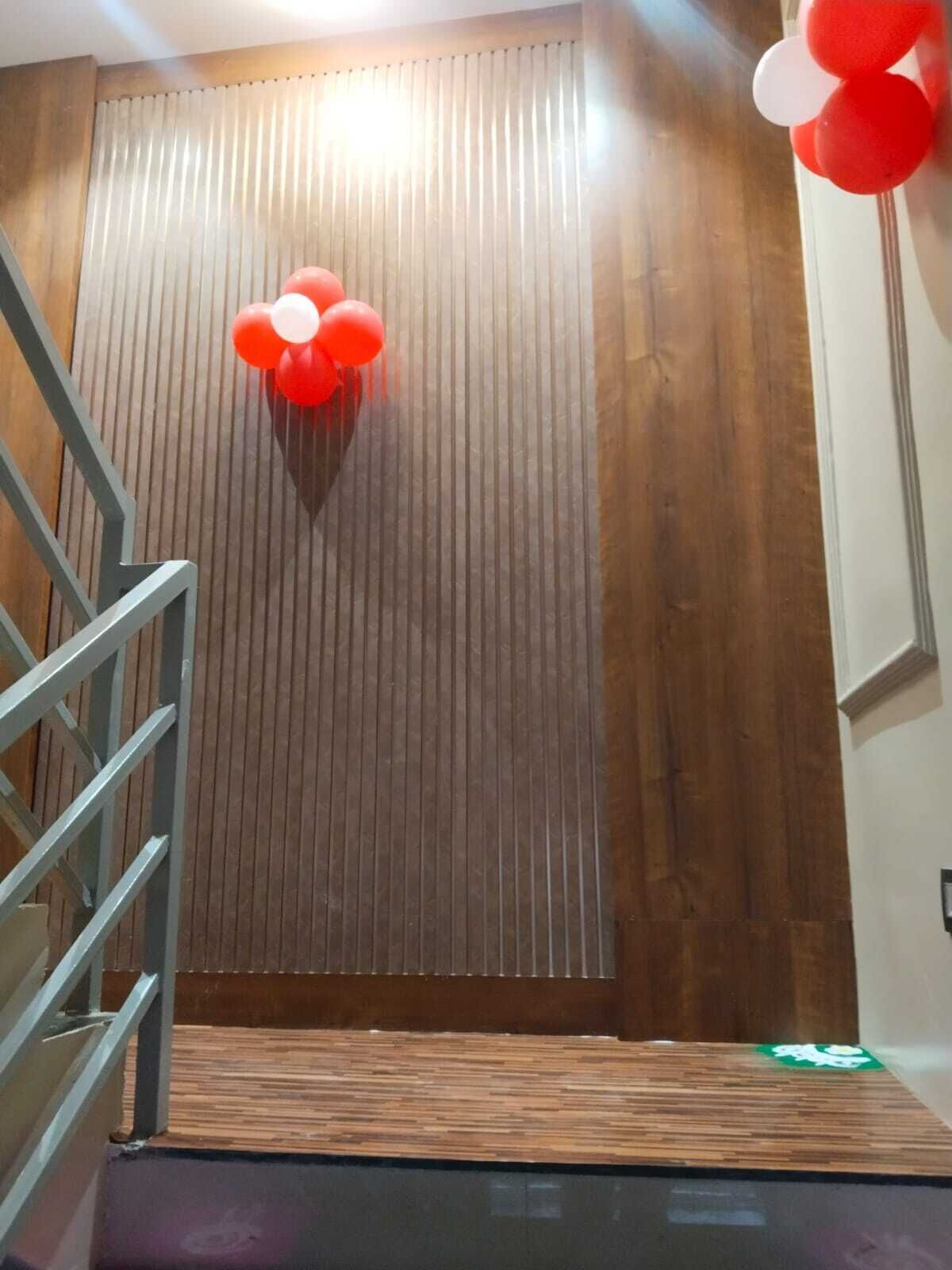 Een trap die leidt naar een kamer met een houten paneelwand en een klein podium.