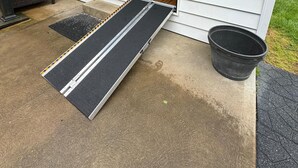 A house with a sliding glass door, a small porch, and a black ramp leading to the door. - Remodeled and Inviting Free EV Charging Station Level 2 (Fenton)