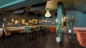 A modern interior with a bar area, seating, and decorative lighting. - FOUND Hotels, Chicago, Series by Marriott (Chicago)