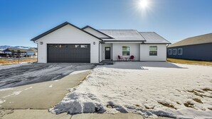 A modern single-story house with a garage, a covered patio, and a snow-covered driveway. - 2 Mi to Beaverhead River: Family-friendly Home! (Dillon)