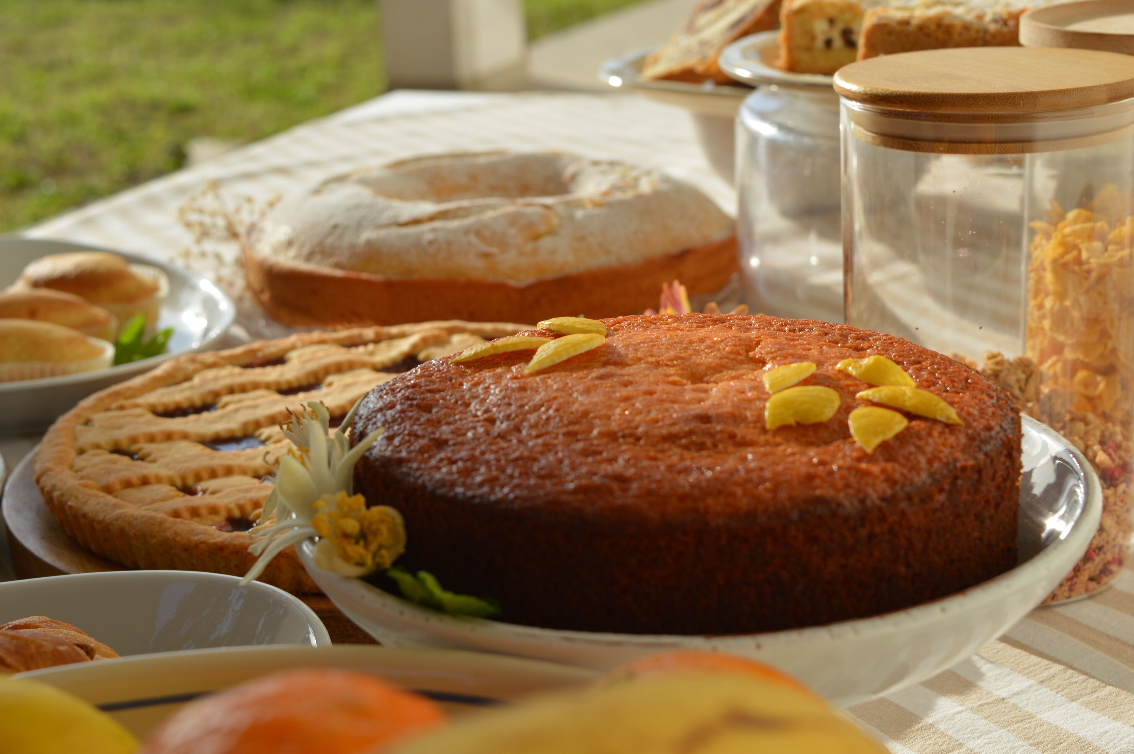A table with various baked goods including a cake, cookies, and pastries.