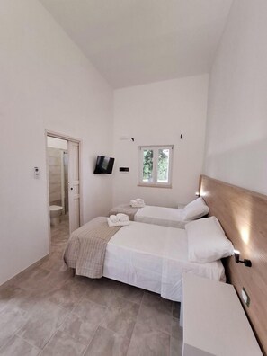 Standard Triple Room | Minibar, desk, laptop workspace, blackout drapes