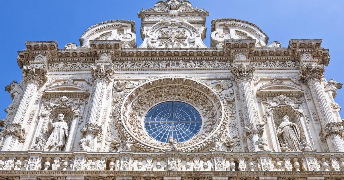 A detailed architectural facade with ornate carvings and statues.