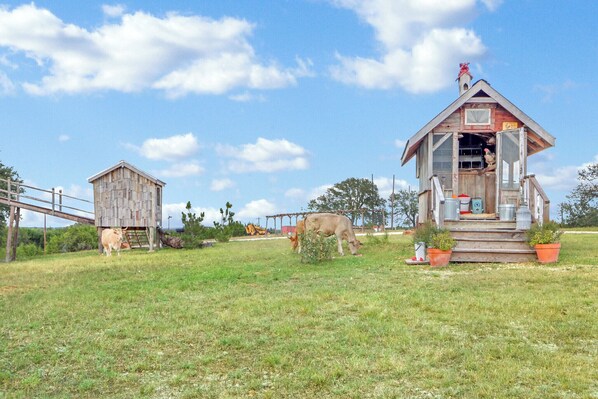 A rustic barn with a wooden exterior and a small porch.