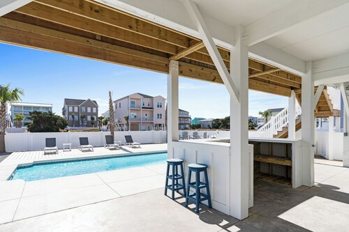 At Last is a newly built 5 bedroom 5 bathroom home with a private pool, elevator, tiki bar and so much more including a short walk to the beach!