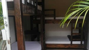 A bunk bed room with a wooden frame, a potted plant, and tiled flooring. - Hostal Hilltop Sapzurro (Sapzurro)