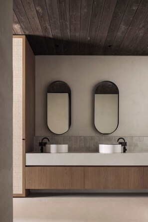 A modern bathroom with two sinks, wooden cabinets, and a dark wooden ceiling. - The Lodge - Luxury Design Villa in Oostduinkerke (Koksijde)