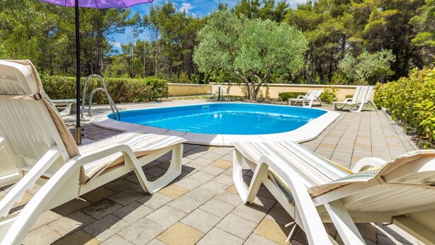 A swimming pool with lounge chairs and an umbrella. - Elegant and Lavish Leisure Apartments Zadar With Outdoor Pool (Zadar)
