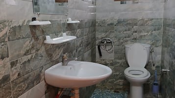 Shower, hair dryer, towels, toilet paper