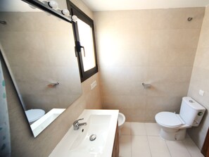 A bathroom with a white sink, mirror, and toilet. - UPPER COAST (Alcoceber / Alcossebre)