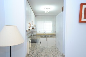Fridge, microwave, coffee/tea maker, cookware/dishes/utensils